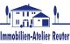 Logo von Immobilien-Atelier Reuter mit Haus und Bäumen in Blau.