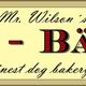 Schild mit der Aufschrift: "Mr. Wilson's Hunde-Bäckerei - finest dog bakery".