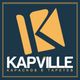 Logo da Kapville, empresa de kapachos e tapetes, com fundo azul e detalhes em amarelo.