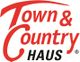 Logo mit rotem "Town & Country" und schwarzem "HAUS", diagonale Schrift auf weißem Hintergrund.