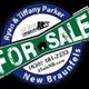 Real estate sign: "For Sale" by Ryan & Tiffany Parker, New Braunfels, with contact info.