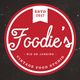 Logo redondo vermelho com texto "Foodie's, Rio de Janeiro, Vintage Food Studio, estd 2017".