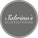 Grauer Kreis mit weißem Text: "Sabrina's Glückssträhne". Minimalistisches Logo-Design.