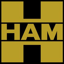 Logo con una gran "H" dorada y la palabra "HAM" en el centro sobre fondo negro.