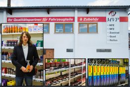 Mann im Anzug in Autozubehörgeschäft. Außenansicht mit Werkzeugen und KFZ-Teilen.