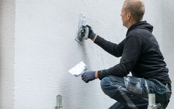 Maler beschichtet die Fassade