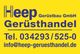Gelbes Schild mit "Heep Gerüstbau GmbH", Telefonnummer und E-Mail für Gerüsthandel.