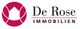 Logo von De Rose Immobilien mit stilisiertem Haus und Text.