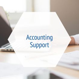 "Hexagon with 'Accounting Support' over a blurred workspace background with a laptop."