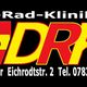 Die-Rad-Klinik Logo mit Fahrrad, rotem Kreuz und Kontaktinfos.