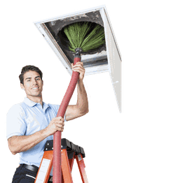 Person on a ladder cleaning air ducts with a brush.