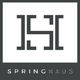 Logo with geometric design above the text "SPRINGHAUS" on a dark background.