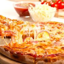 Cheesy pizza slice being lifted, with sauce and cheese in the background.