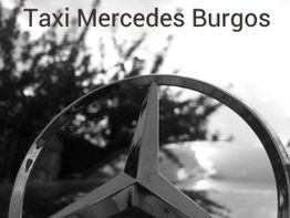 Emblema de Mercedes en primer plano con texto "Taxi Mercedes Burgos" arriba.