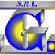 Logo con scritta "S.R.L. T.G.S." in blu, grigio e giallo su sfondo bianco.