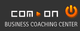 Logo mit Text: "com on" und "Business Coaching Center" auf dunklem Hintergrund.