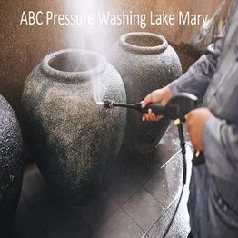 Person pressure washing large vases with text "ABC Pressure Washing Lake Mary" above.
