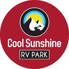 Red circular logo for Cool Sunshine RV Park with mountain and sun design.