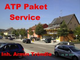 Straßenszene mit Gebäuden und Autos, Text: "ATP Paket Service. Inh. Armin Tröndle".