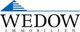 Logo von Wedow Immobilien mit blauem Dachsymbol und Schriftzug in Schwarz.