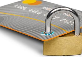 Credit card secured with a padlock, symbolizing financial security and protection.