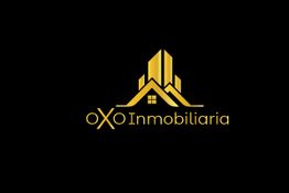 Logotipo dorado de OXO Inmobiliaria con edificios estilizados sobre fondo negro.