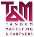 Logo von Tandem Marketing & Partners in pinkfarbenen Buchstaben auf weißem Hintergrund.