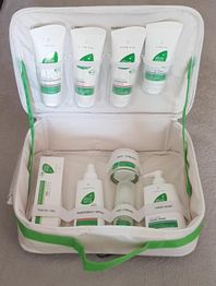 Kosmetiktasche mit verschiedenen Aloe-vera-Produkten in Tuben und Flaschen.