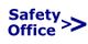 Text "Safety Office" mit zwei rechten Pfeilen auf weißem Hintergrund.
