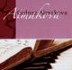 Buchseite und Klavier, darüber Text "Gulnaz Aimakova" vor lila Hintergrund.