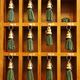 Wooden cubbies holding green tassel keychains, neatly organized in three rows.