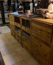 Madera rústica en el interior de un restaurante con estatuas de personas en ambos extremos.