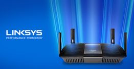Linksys router with glowing blue beams and "Performance Perfected" slogan on a blue background.