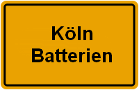 Gelbes Schild mit der schwarzen Aufschrift: "Köln Batterien".