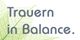 Textbild mit der Aufschrift „Trauern in Balance“ auf grünem Blatt.