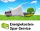 Energiespar-Service-Werbung mit Glühbirne, Windrad, Baum und Ökostrom-Schild auf grünem Rasen.
