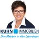 Frau mit Brille lächelt, "KUHN IMMOBILIEN" Logo und Slogan: "Ihre Maklerin in allen Lebenslagen".