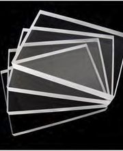 Varias láminas acrílicas traslúcidas superpuestas sobre fondo negro.