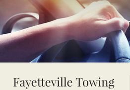 Hand on steering wheel with "Fayetteville Towing" text below.