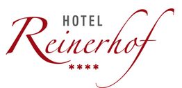 Schriftzug "Hotel Reinerhof" in eleganter roter Schrift mit vier roten Sternen darunter.