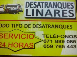 Anuncio de Desatranques Linares, servicio 24 horas, con dos números de teléfono de contacto.