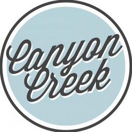 Circular logo with "Canyon Creek" in cursive on a light blue background.
