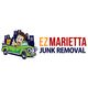Cartoon man in green car with text "EZ Marietta Junk Removal."