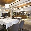 Elegant restaurant interior with neatly set tables, modern lighting, and a welcoming atmosphere.