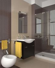Baño moderno con mueble negro, toallas amarillas y ducha con mampara de vidrio.