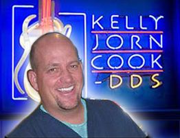 Smiling person with "Kelly Jorn Cook DDS" sign in the background.