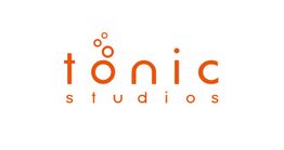 "Tonic Studios logo with orange letters and small circular designs above the 'o'."