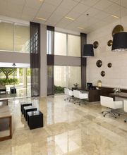 Espacio interior moderno con escritorios blancos, sofás y decoración en paredes.