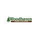 "Woodhaven Lumber & Millwork logo with green trees and brown bar below the company name."