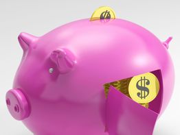 Pink piggy bank with dollar coins being inserted and visible through an open hatch.